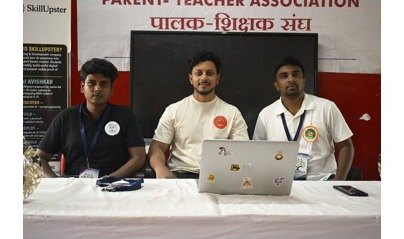 The SkillUpster team at a laptop on the event demonstration table